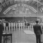 I Påsken 1957 lagde Tennishallen gulv til en
landskamp i redskabsgymnastik mellem Danmark
og Holland. Det var HfS og i særdeleshed den
tredobbelte DM-holdvinder for Viborg og formand
for klubbens gymnastikafdeling, Svend Andersen,
som havde fået landskampen til Horsens.
Trods trange fysiske rammer klappede alt som
det skulle. De 1.000 tilskuere oplevede elegance
og imponerende sikkerhed hos det danske hold,
der sejrede med 335,75 point mod hollændernes
331,40.
T. h. med ryggen til byder Svend Andersen velkommen til gymnaster og publikum.
PRIVATFOTO / HORSENS IDRÆTSARKIVS SAMLING
